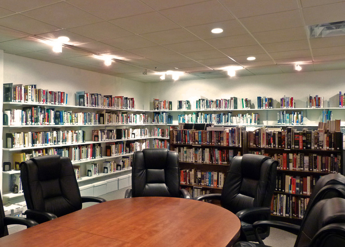 A library room with conference table and chairs in the center