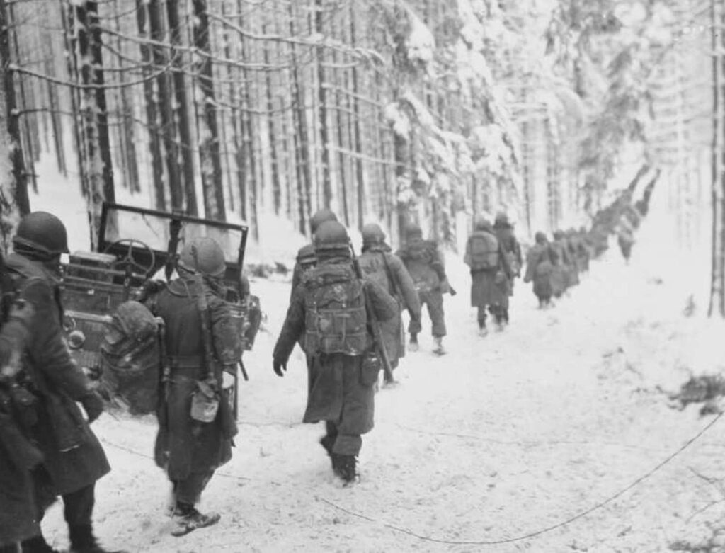 Soldiers walking through snow WWII