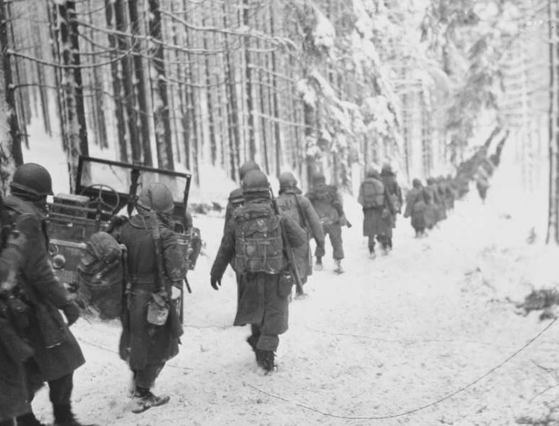 Soldiers walking through snow WWII