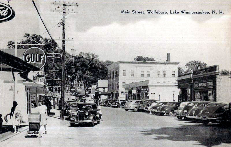 Looking down Main Street in Wolfeboro, a photograph shows buildings and cars of the 1940's