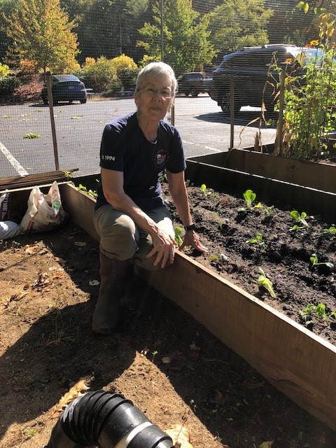 Volunteer Chrisy tending to garden