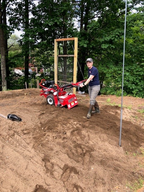 Volunteer Chrissy tilling the soil